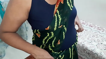 A Seductive Desi Bhabhi In A Dark Green Saree, Her Curves Tempting And Her Gaze Inviting